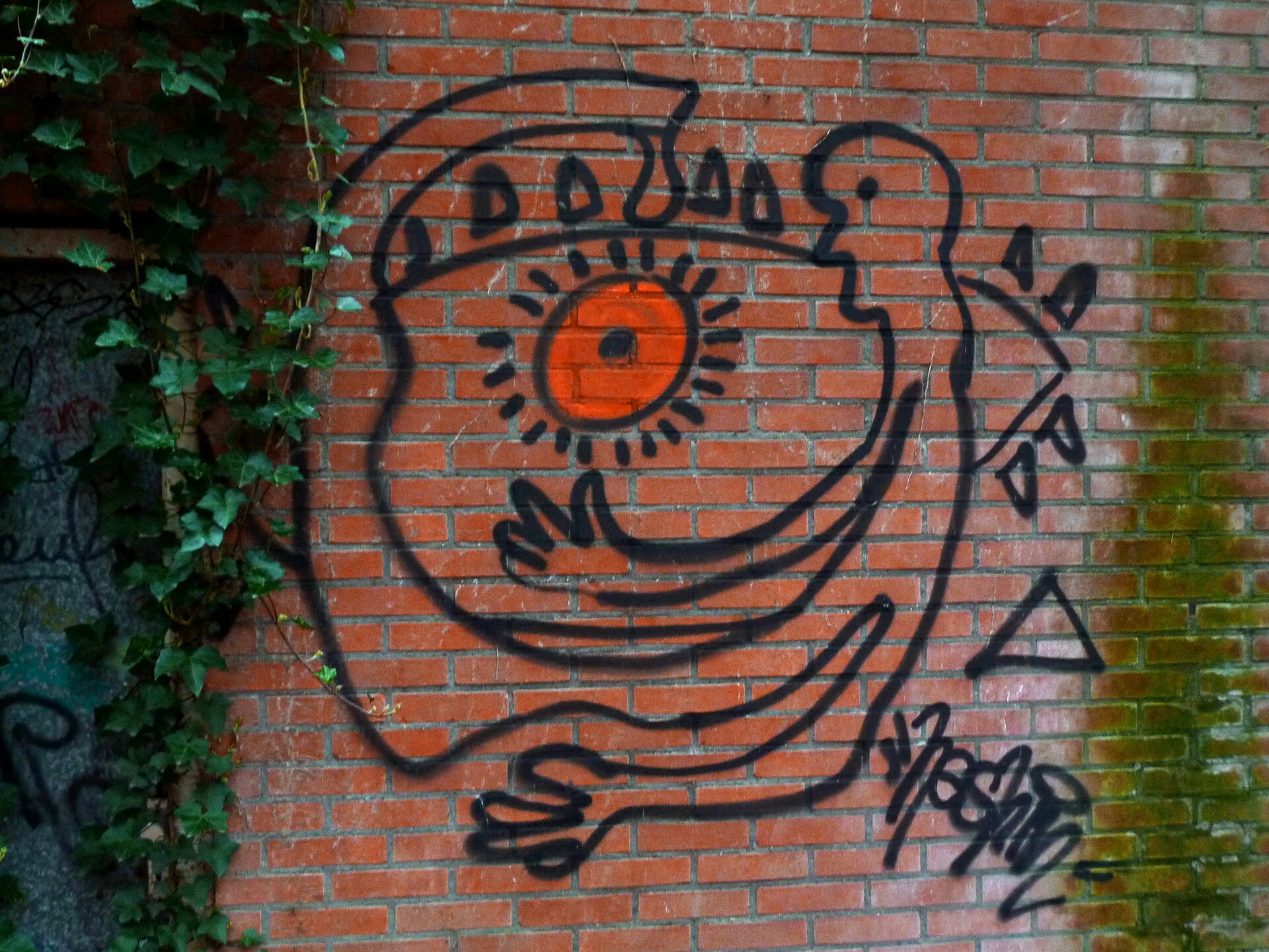 Black line painting on a brick wall